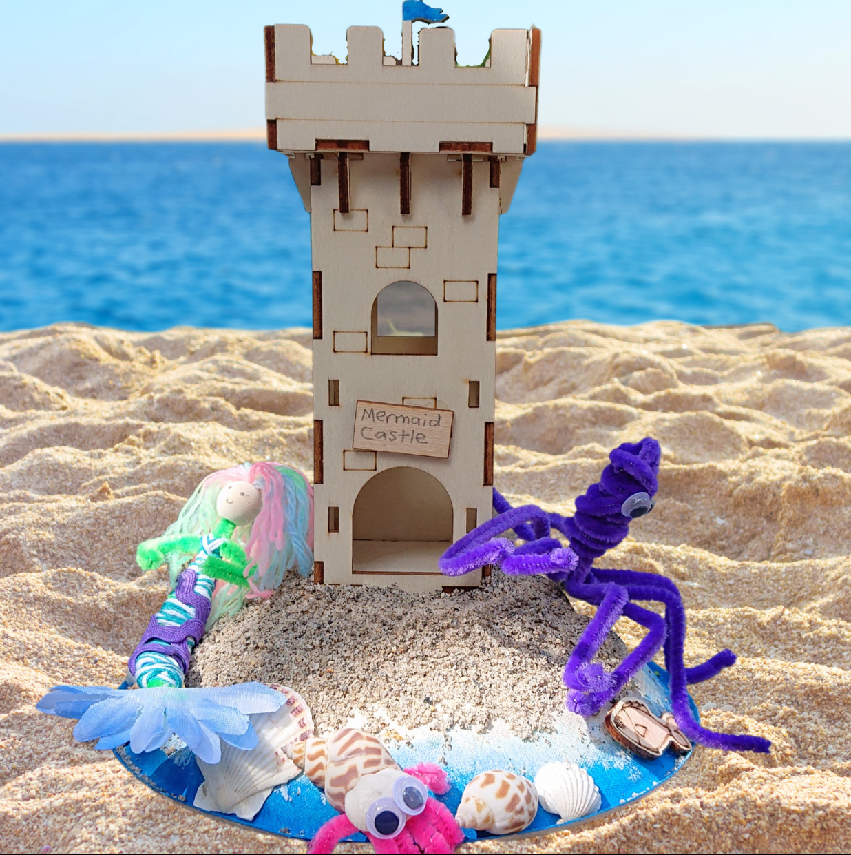 Sand castle with mermaid and octopus on a beach setting