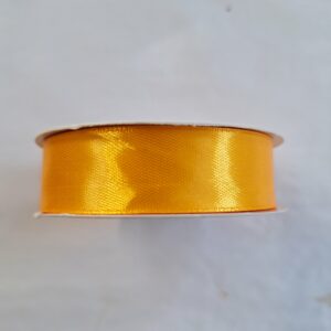 A roll of 2cm amber coloured satin ribbon